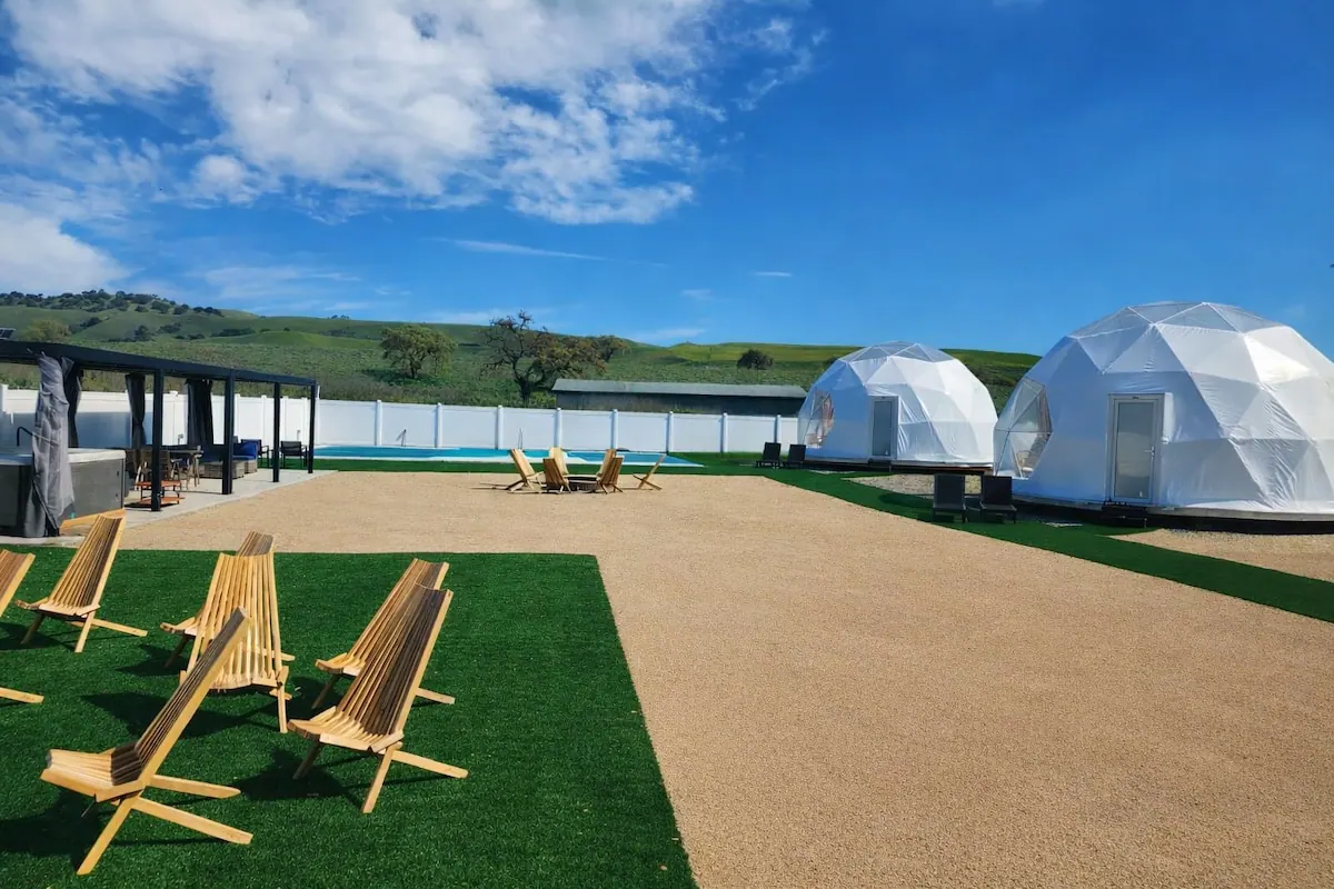 Lounge chairs on the lawn facing the geodesic domes